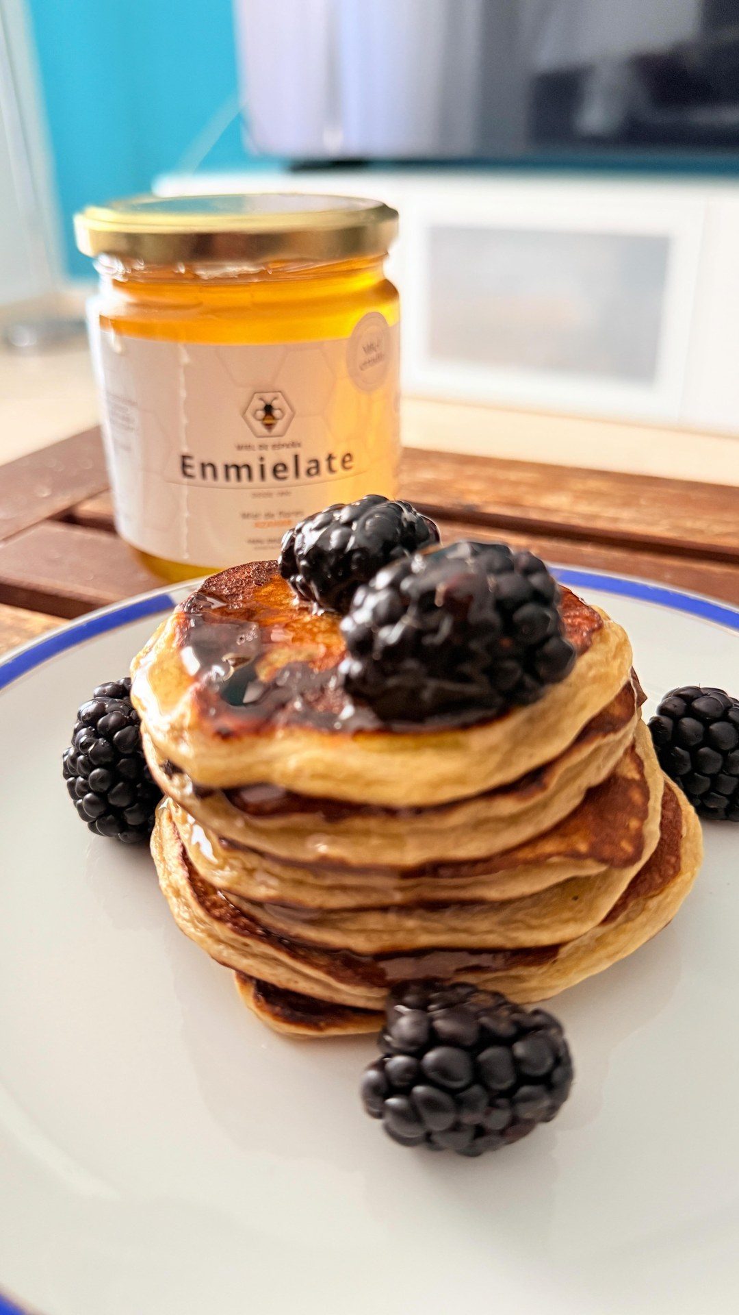 Fotograma del vídeo: tortitas con miel y moras junto a un tarro de Enmiélate